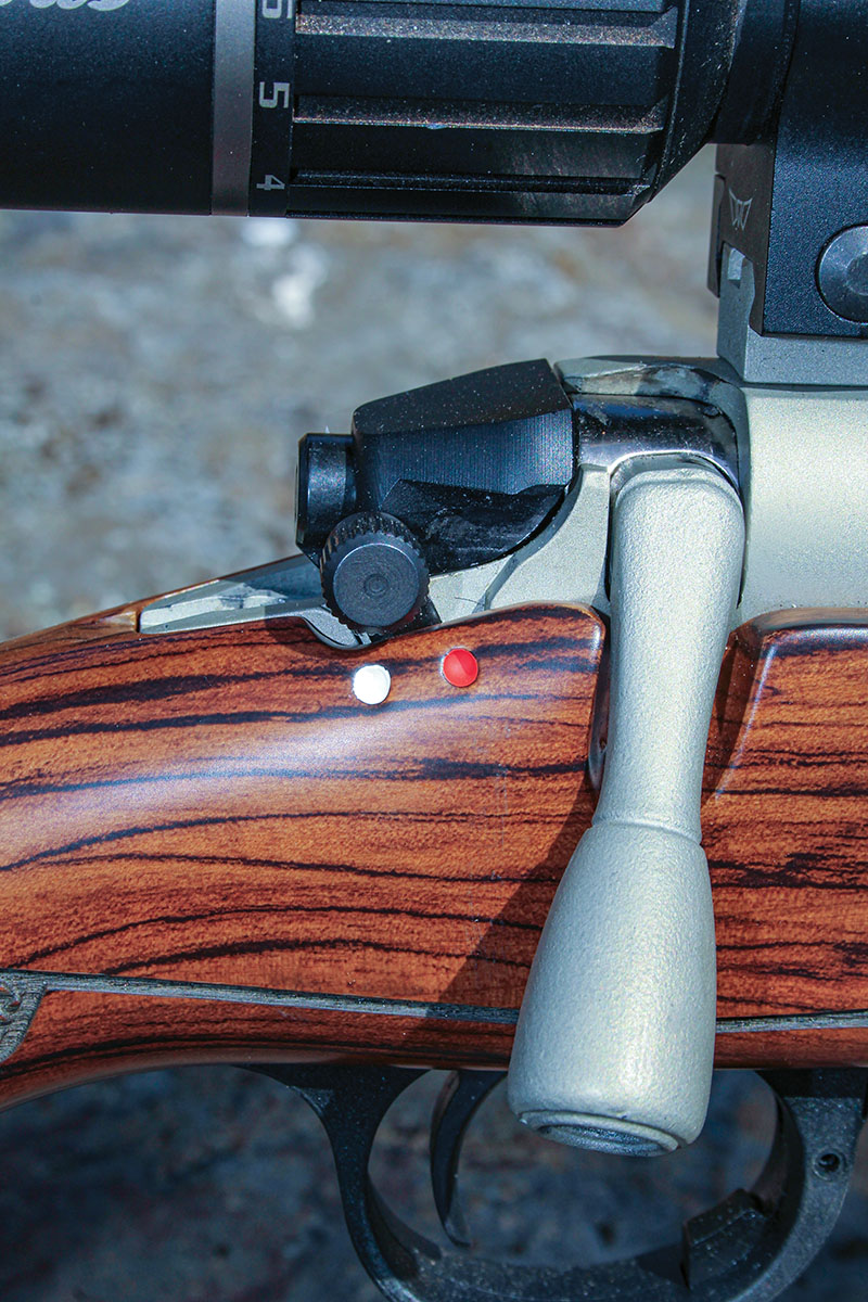 The safety of the Elite is a simple two-position system. White (safe) and red (fire) dots are included. The safety does not lock the bolt, allowing unloading the rifle with the safety engaged.